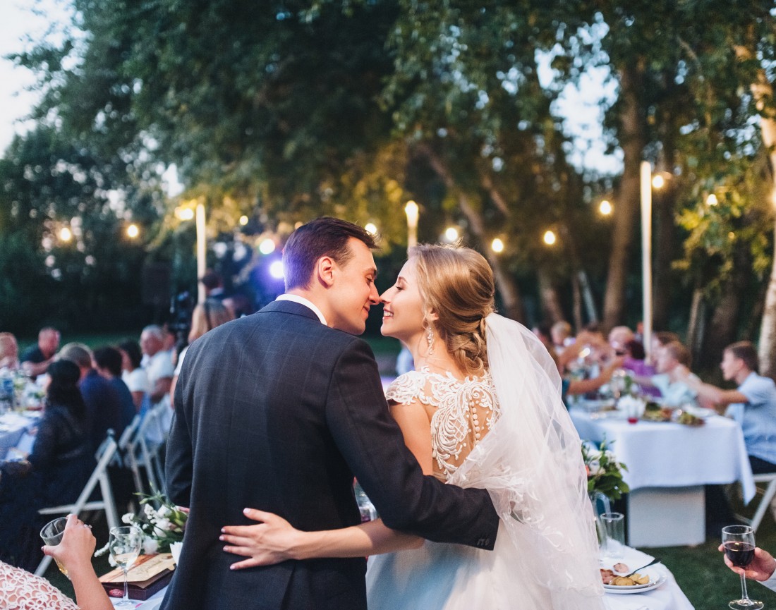 Photo of a groom and bride kissing each other